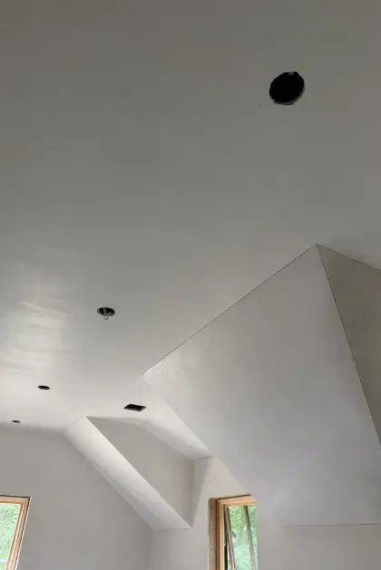 Smooth plaster finish across angular dormer ceilings