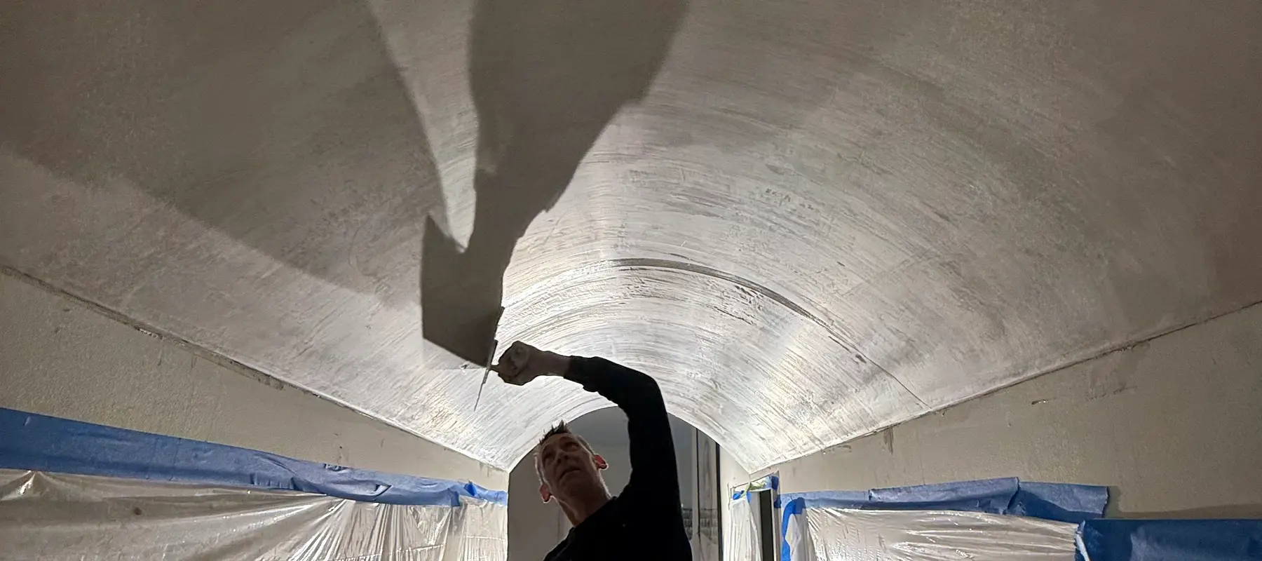Finished plaster walls and curved ceiling in a renovated interior