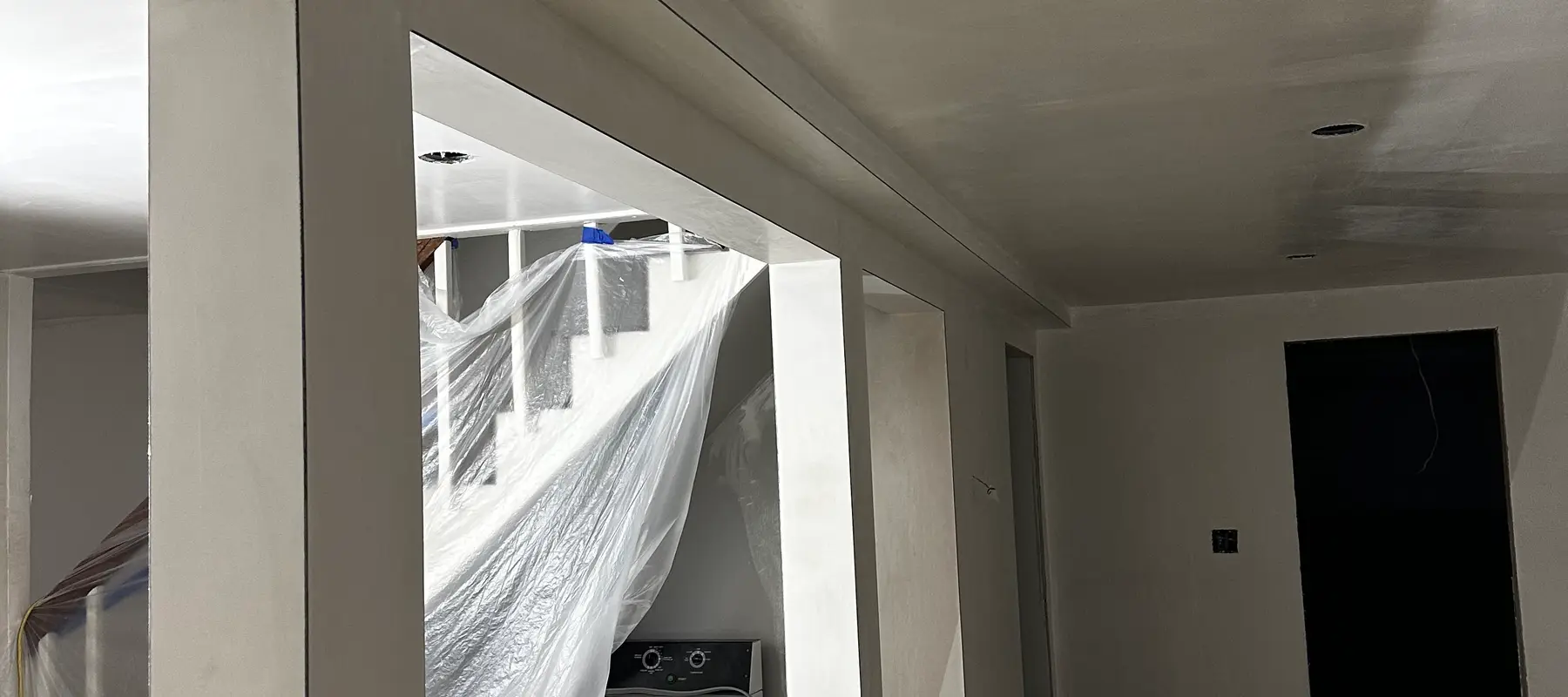 New drywall installed in a finished basement renovation
