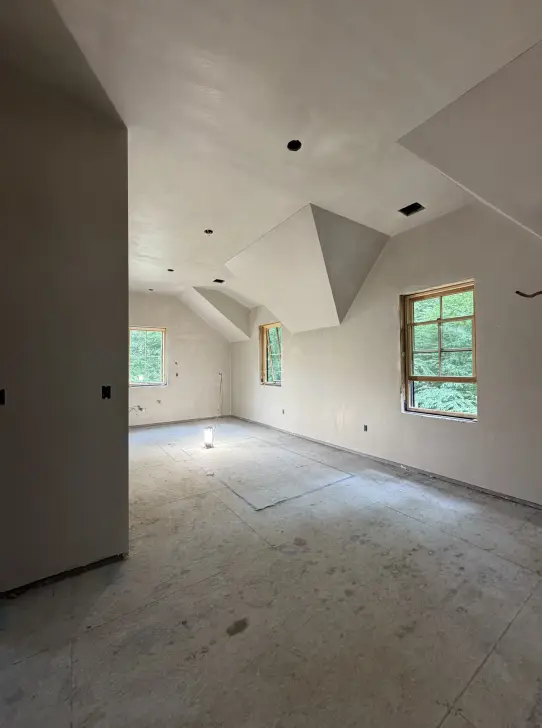 Smooth plaster walls and angular dormer ceiling in a renovation