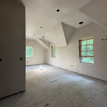 Smooth plaster walls and angular dormer ceiling in a renovation