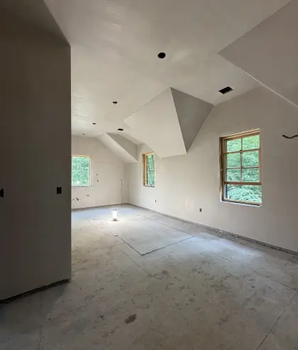Smooth plaster walls and angular dormer ceiling in a renovation