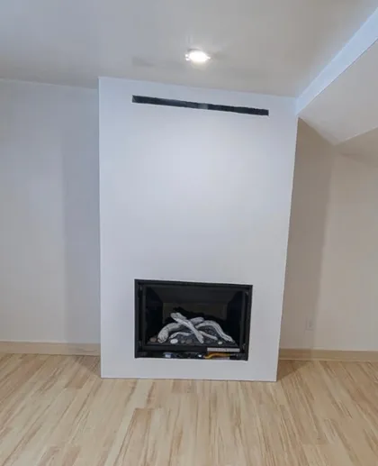 finished fireplace surround with hardwood floors