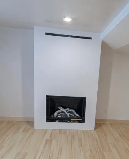 finished fireplace surround with hardwood floors