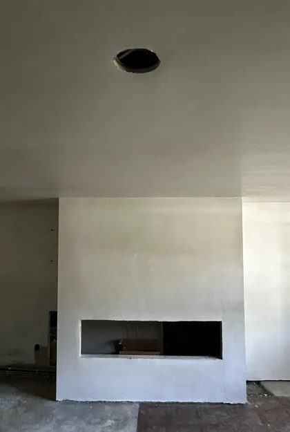 plastered fireplace surround with ceiling detail