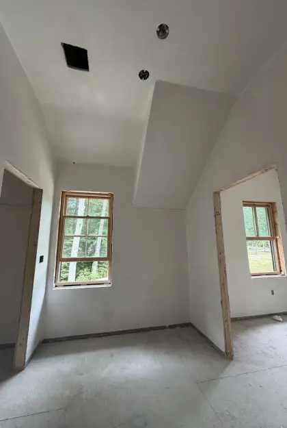 Freshly plastered hallway walls and ceiling around door openings