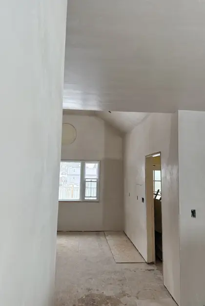 hallway view into vaulted ceiling plastering project