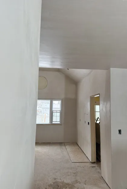 hallway view into vaulted ceiling plastering project