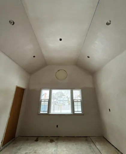 new construction vaulted ceiling plastering with round window