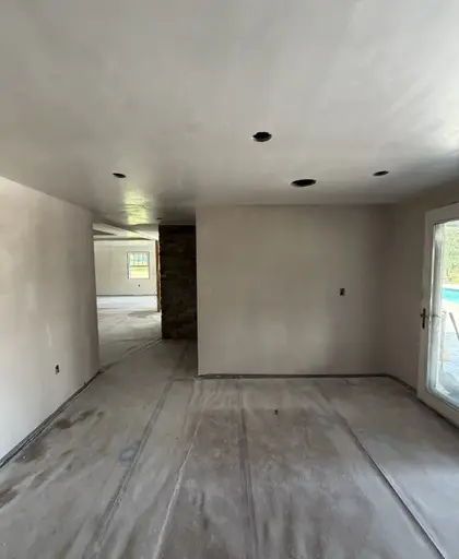 open-plan room with freshly plastered walls and ceiling