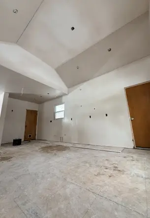 Patriot Plastering worker finishing wall