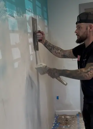 Patriot Plastering worker plastering wall