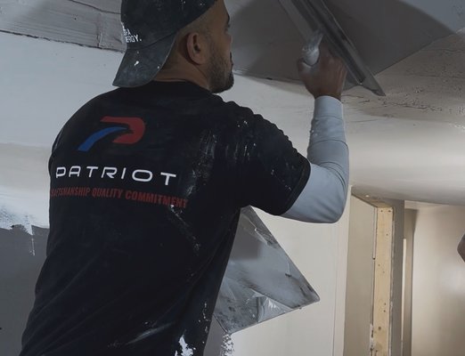 Patriot Plastering expert applying drywall finish in Quincy MA