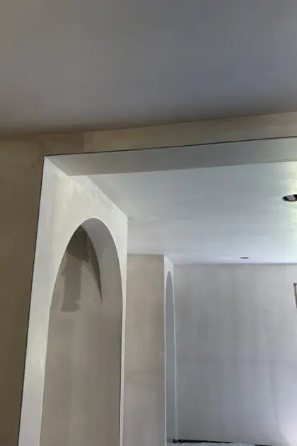 smooth plaster finish around an arched doorway