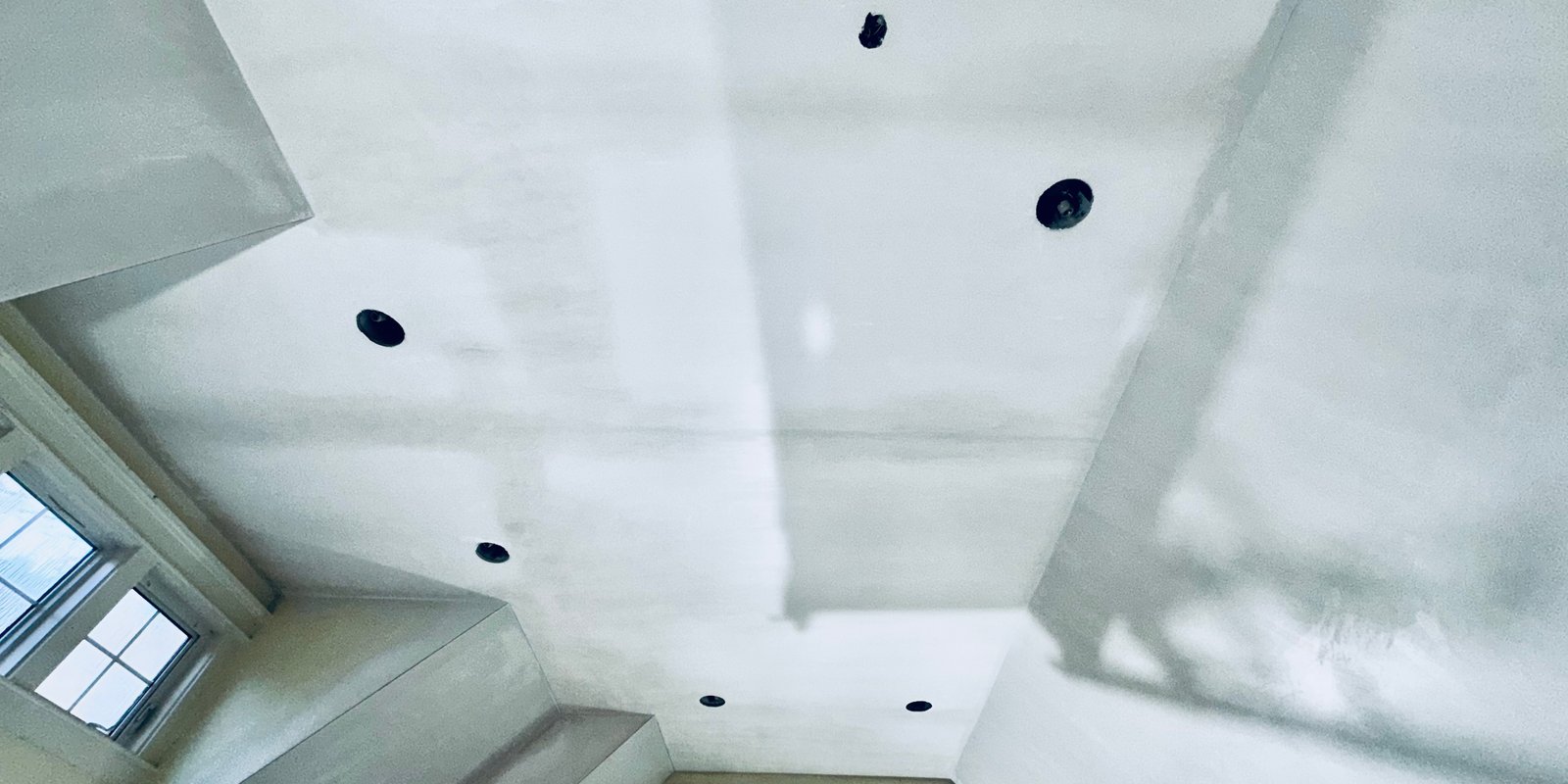 Veneer plaster finish in progress across a cathedral ceiling