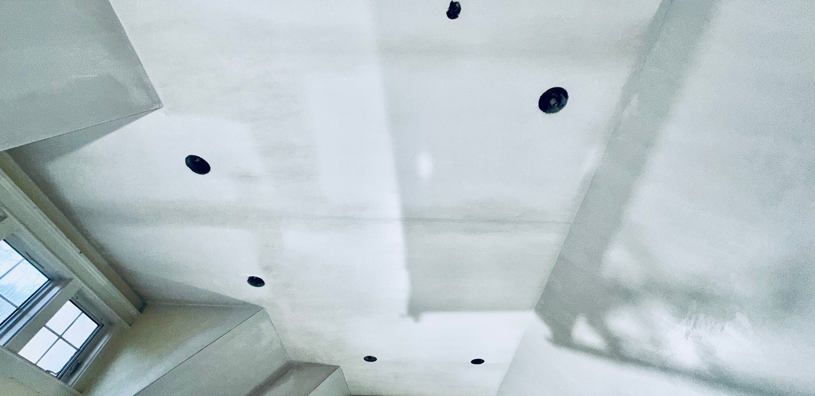 Veneer plaster finish in progress across a cathedral ceiling