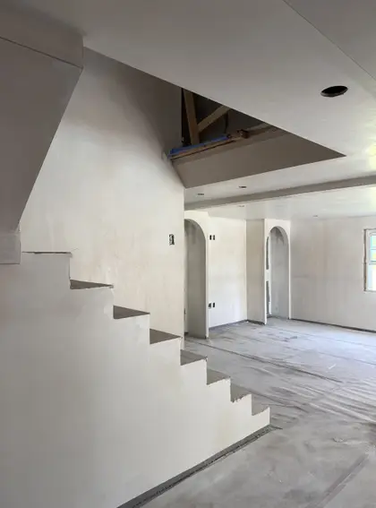 smooth plaster finish along a staircase wall