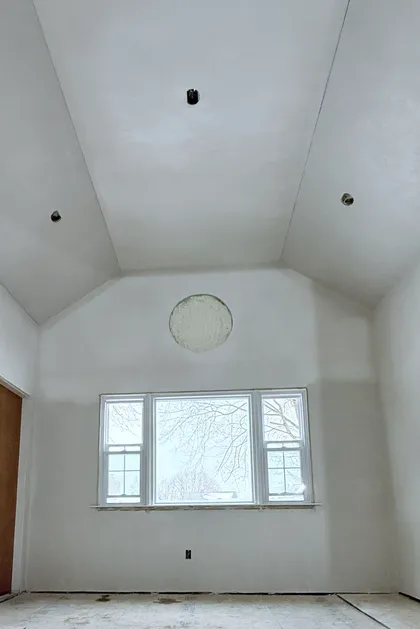 plastered vaulted ceiling with round window