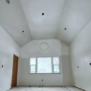 plastered vaulted ceiling with round window