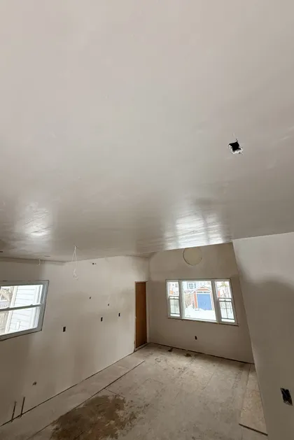 plastered room with sloped ceiling