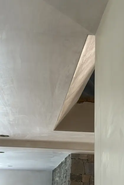 smooth plaster ceiling detail above a stairwell