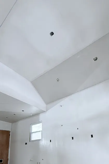 tray ceiling with recessed lighting and smooth plaster